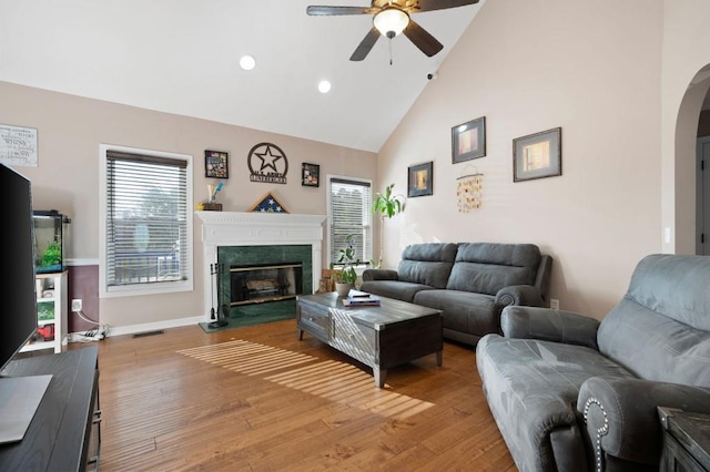 living room featuring ceiling fan, hardwood / wood-style floors, and high vaulted ceiling