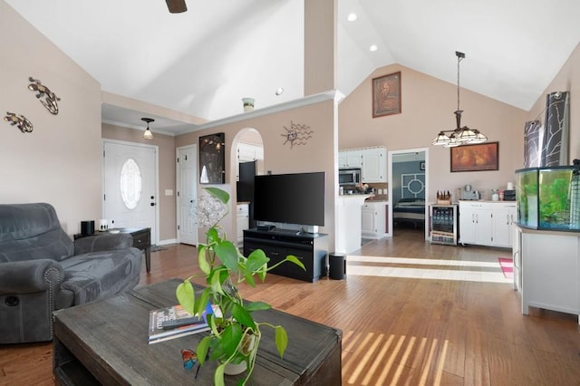 living room featuring high vaulted ceiling, ceiling fan, dark hardwood / wood-style floors, and beverage cooler