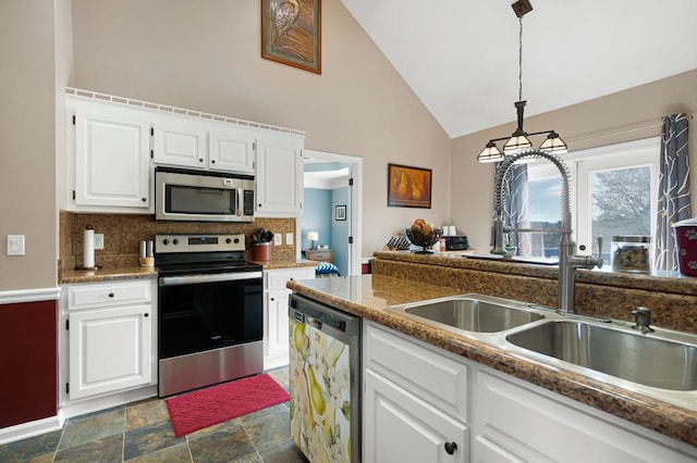 kitchen featuring backsplash, sink, white cabinetry, hanging light fixtures, and stainless steel appliances