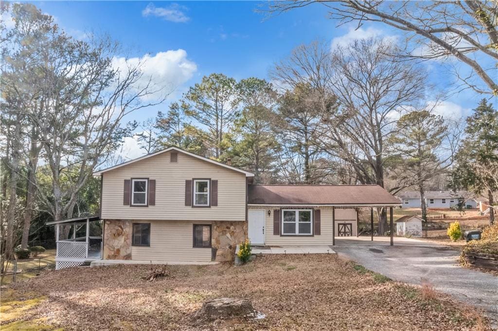 tri-level home with a sunroom and a carport