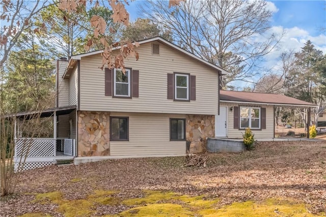 rear view of house featuring covered porch