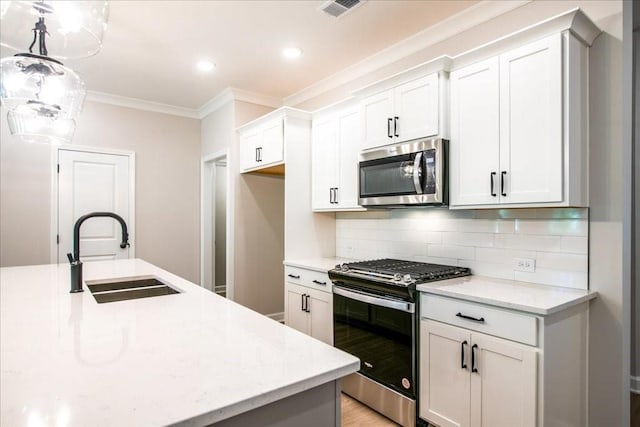 kitchen with stainless steel appliances, a sink, ornamental molding, backsplash, and pendant lighting