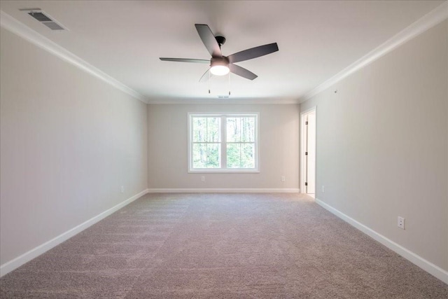 carpeted empty room with crown molding, ceiling fan, and baseboards