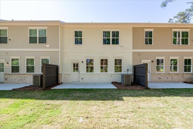 rear view of property with brick siding, a patio, and cooling unit