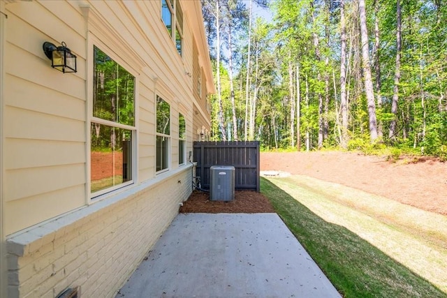 view of yard featuring central AC and a patio