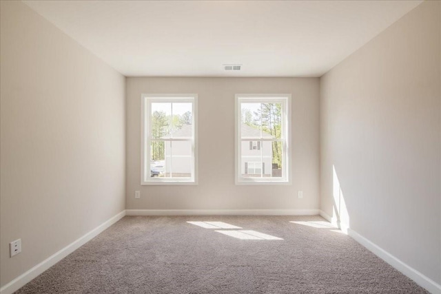 carpeted empty room with baseboards
