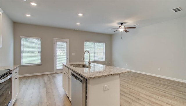 kitchen featuring an island with sink, stainless steel appliances, a healthy amount of sunlight, and sink