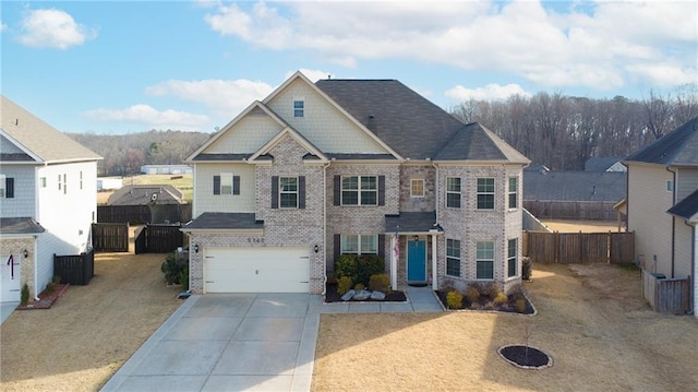 view of front of home featuring brick siding, concrete driveway, a garage, and fence