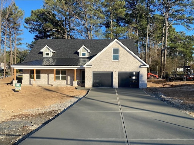 view of front of house with a garage, concrete driveway, and brick siding