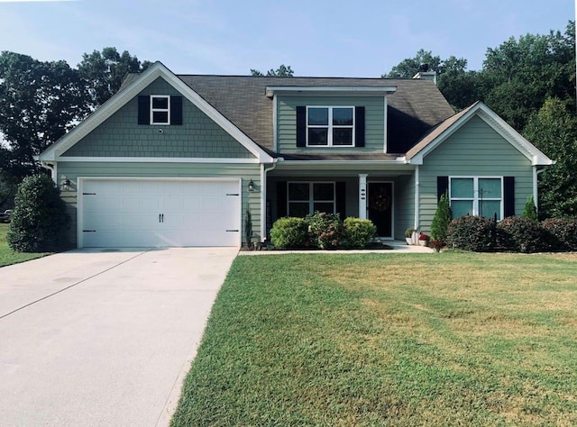 craftsman house with a front lawn and a garage