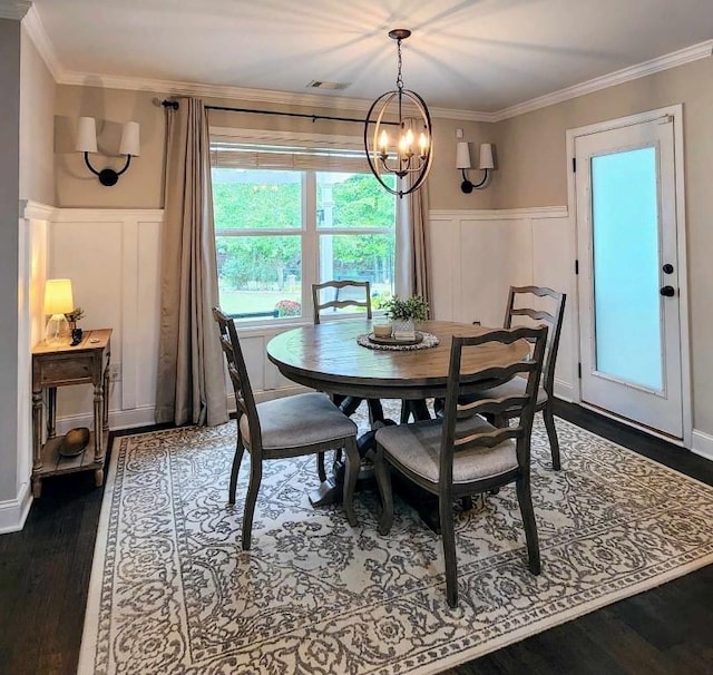 dining room featuring a chandelier, dark hardwood / wood-style floors, and ornamental molding