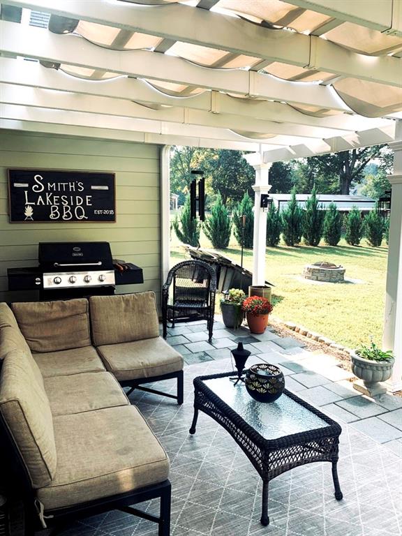 view of patio / terrace featuring area for grilling, a pergola, and an outdoor living space with a fire pit