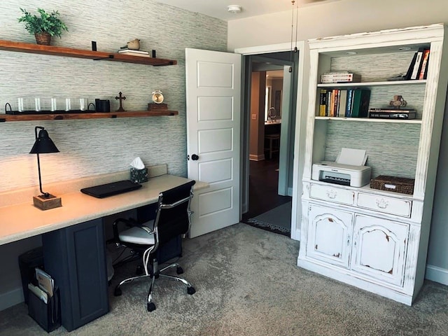 office area with dark colored carpet and built in desk