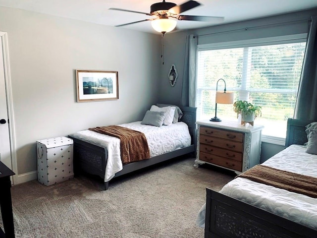 bedroom featuring ceiling fan and carpet