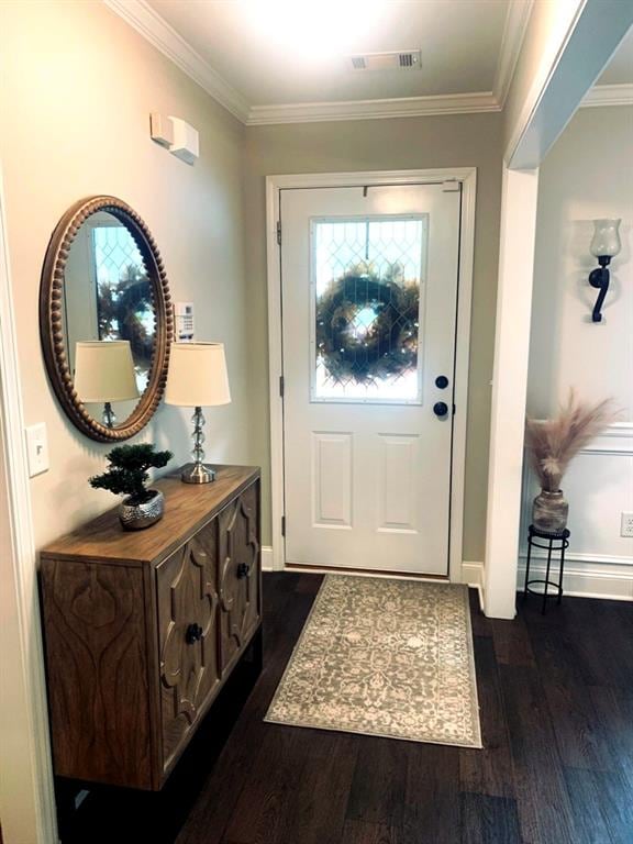 doorway with dark hardwood / wood-style floors and ornamental molding