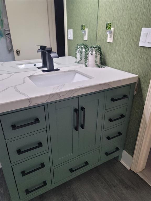 bathroom with vanity and hardwood / wood-style flooring