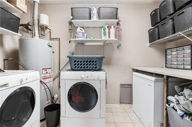 laundry room featuring gas water heater, separate washer and dryer, and light tile patterned flooring