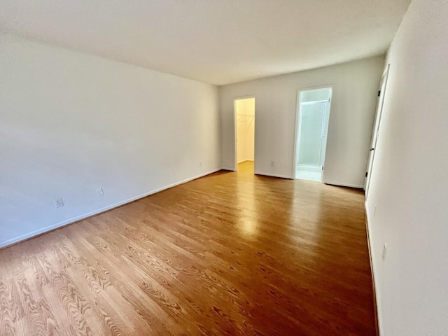 spare room with light wood-style flooring and baseboards