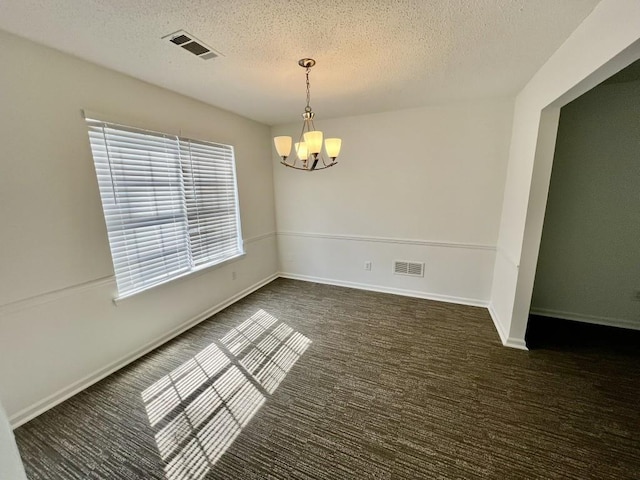 carpeted empty room with visible vents, a textured ceiling, baseboards, and an inviting chandelier