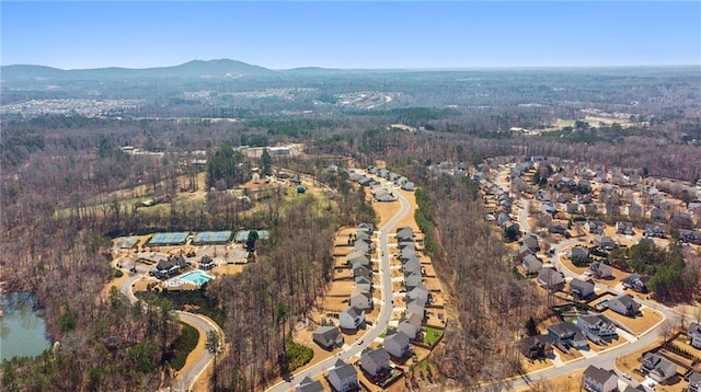 drone / aerial view featuring a forest view and a mountain view