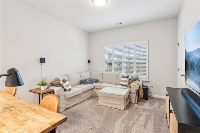 living room featuring baseboards, visible vents, and light carpet