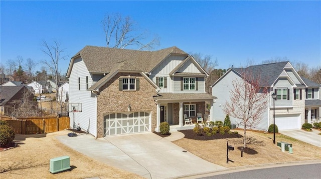 view of front of house featuring fence, covered porch, concrete driveway, a garage, and board and batten siding