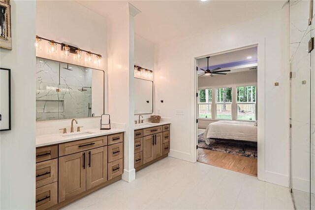 2625 Beverly Ln, Snellville, GA 30078 - full bath featuring a ceiling fan, a marble finish shower, two vanities, ensuite bathroom, and baseboards
