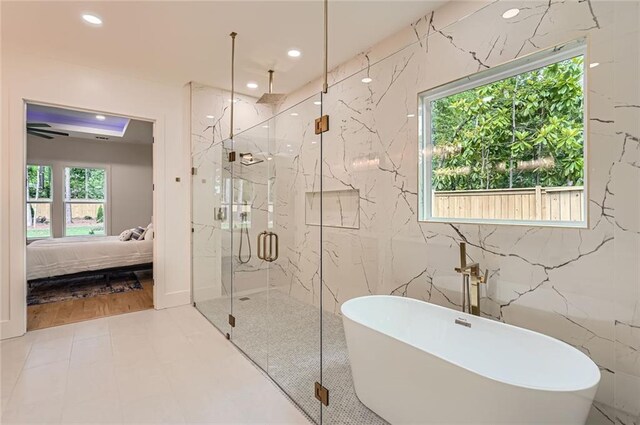 2625 Beverly Ln, Snellville, GA 30078 - ensuite bathroom with a marble finish shower, a soaking tub, recessed lighting, and tile walls