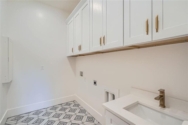 2625 Beverly Ln, Snellville, GA 30078 - laundry area with electric dryer hookup, cabinet space, hookup for a washing machine, and baseboards