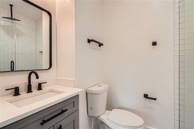 2625 Beverly Ln, Snellville, GA 30078 - bathroom with vanity, toilet, and a tile shower