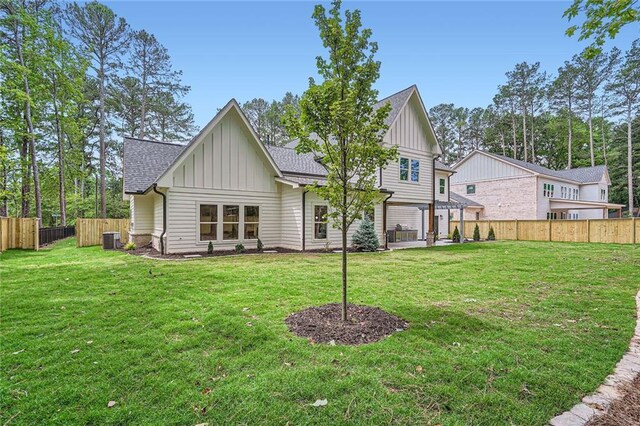 2625 Beverly Ln, Snellville, GA 30078 - back of house with board and batten siding, central AC, and roof with shingles