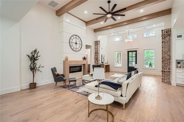 2625 Beverly Ln, Snellville, GA 30078 - living room with a glass covered fireplace, light wood finished floors, recessed lighting, baseboards, and beamed ceiling