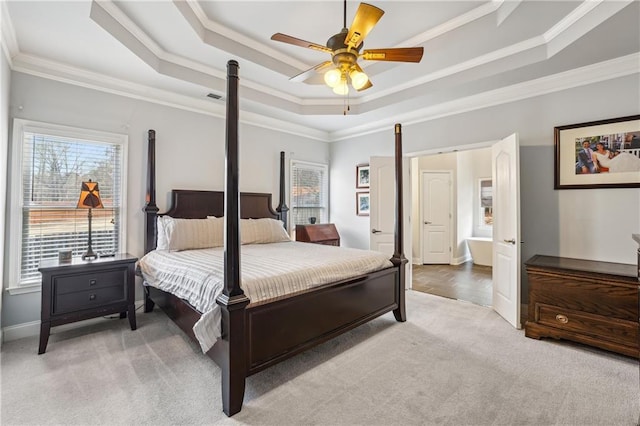 bedroom featuring visible vents, a tray ceiling, carpet flooring, and ornamental molding