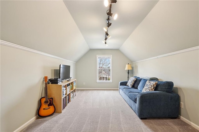 interior space featuring rail lighting, carpet, baseboards, and vaulted ceiling