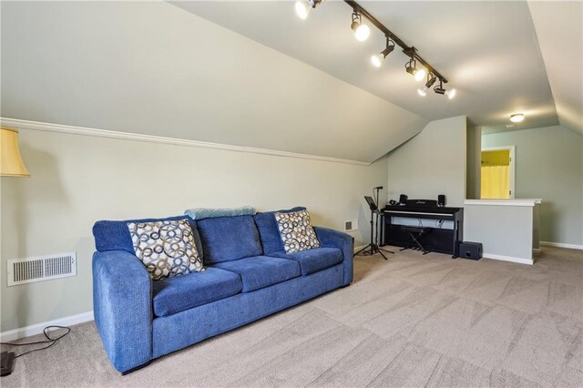 living area with vaulted ceiling, carpet flooring, visible vents, and baseboards