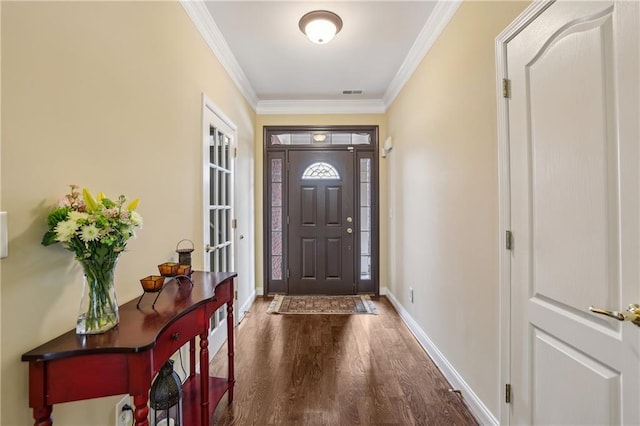 entrance foyer featuring ornamental molding, wood finished floors, visible vents, and baseboards