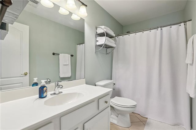 bathroom with toilet, vanity, tile patterned flooring, and visible vents