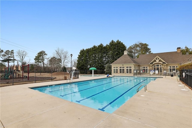 pool featuring a patio area and fence