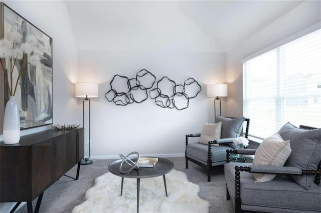 carpeted living room featuring lofted ceiling