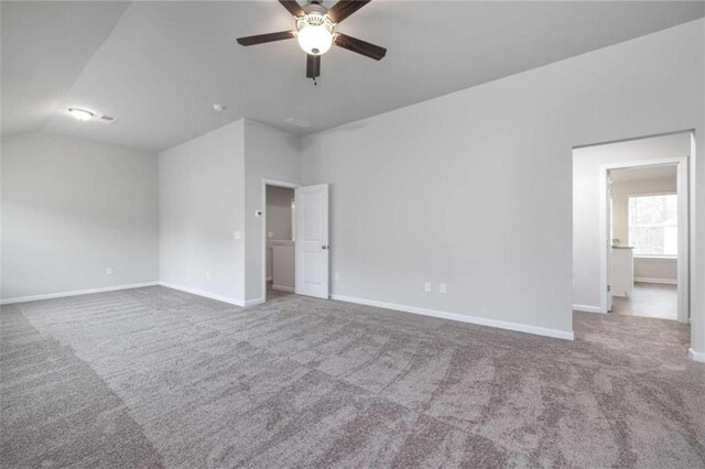 unfurnished room featuring ceiling fan, carpet floors, and lofted ceiling