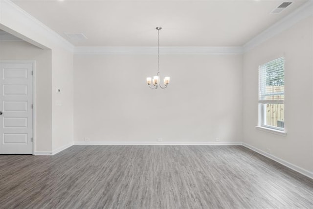 empty room with ornamental molding, hardwood / wood-style floors, and a notable chandelier