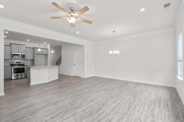 unfurnished living room with crown molding, ceiling fan with notable chandelier, and light hardwood / wood-style flooring