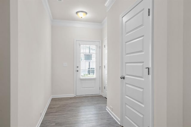 entryway with ornamental molding and light hardwood / wood-style flooring