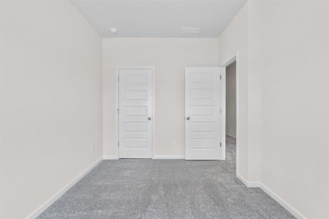 unfurnished bedroom featuring light carpet