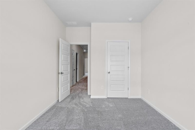 unfurnished bedroom featuring carpet