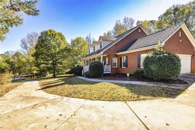 view of property exterior with a lawn, a porch, and a garage