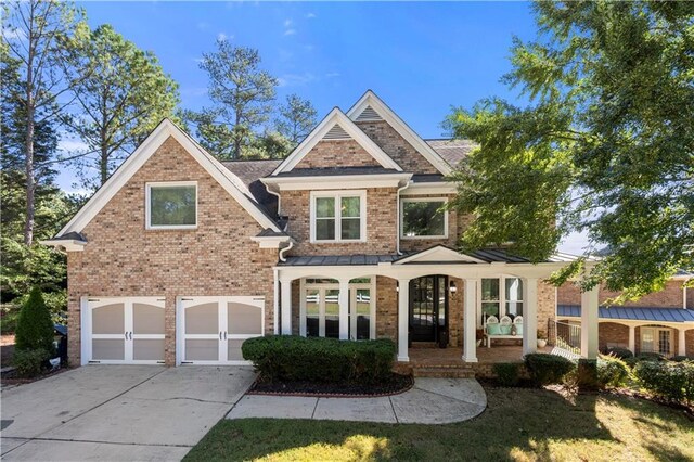 view of front facade featuring a porch and a garage