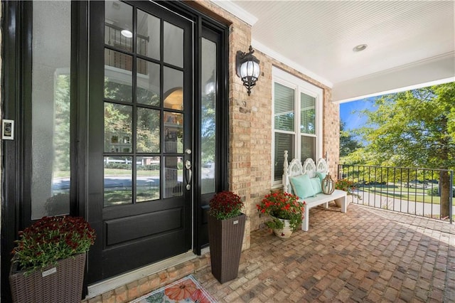 view of exterior entry featuring a porch