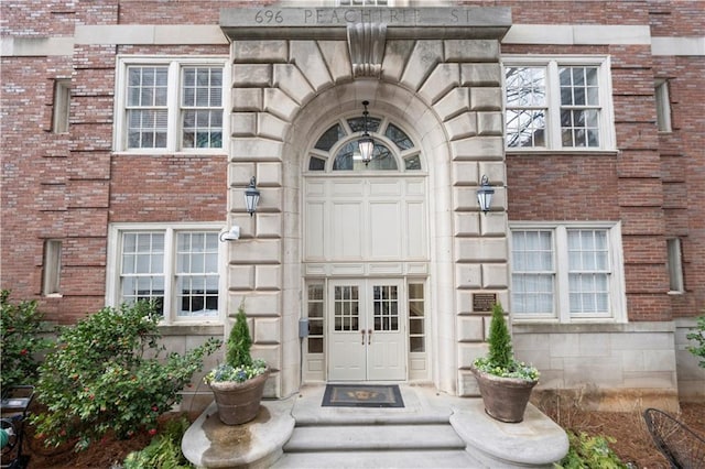 entrance to property with stone siding and brick siding