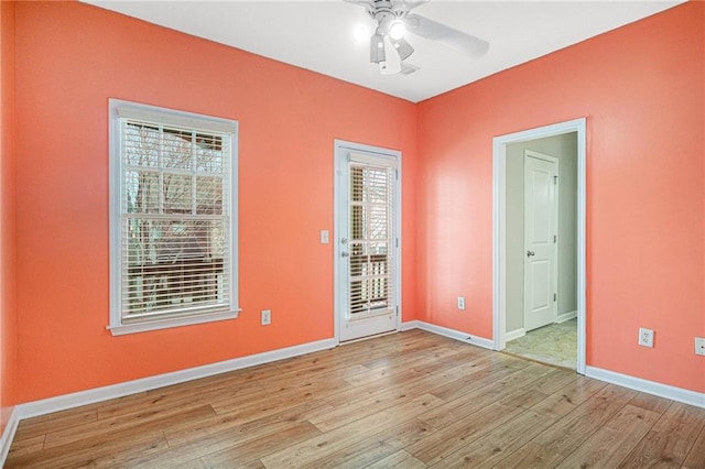 unfurnished room featuring ceiling fan, baseboards, and wood finished floors